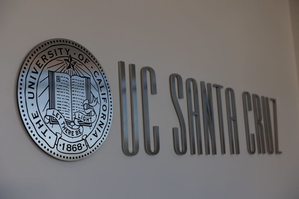 Wall signage of UC Santa Cruz logo and seal.