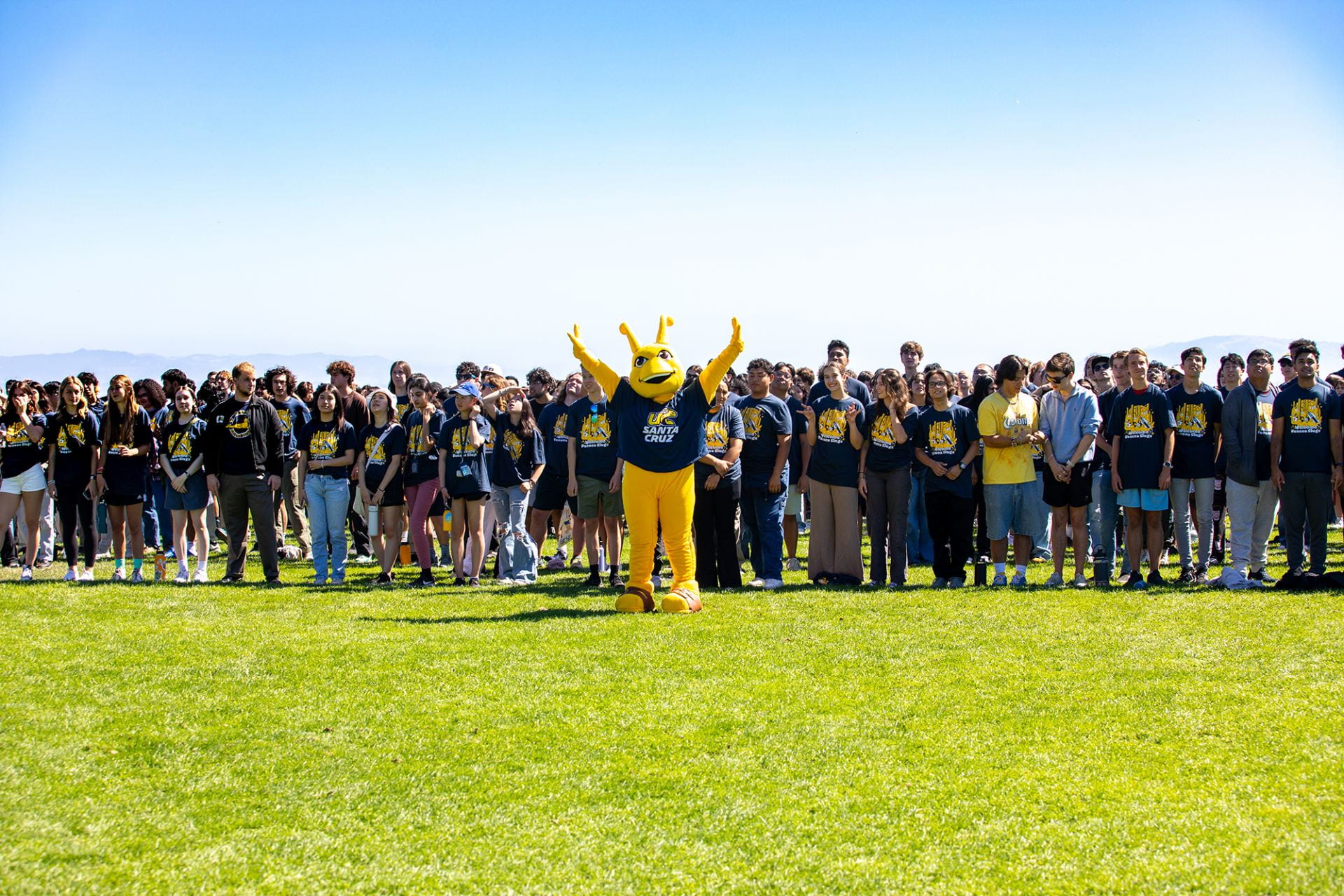 big group of students posing for a photo with the campus mascot, Sammy the Slug